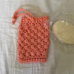 Handmade soap holding coral colored washcloth
